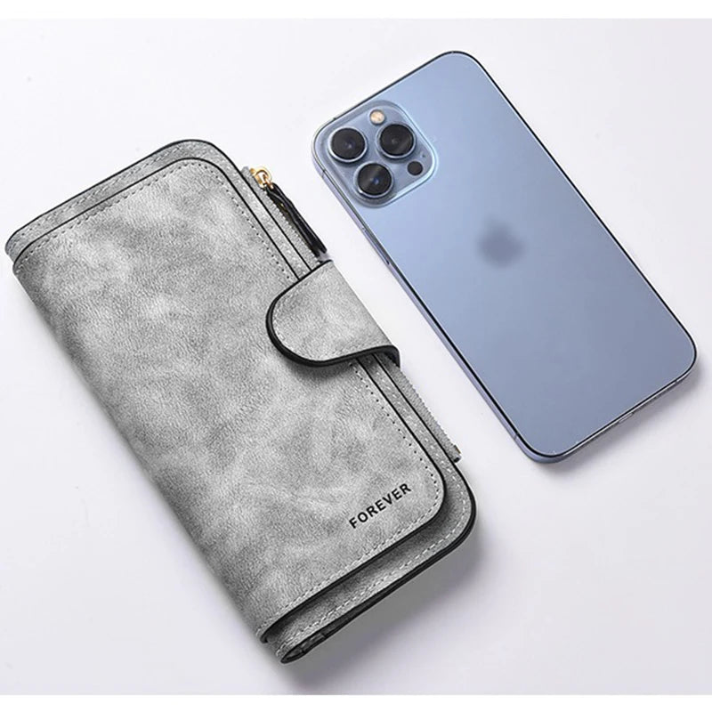A gray faux leather zippered wallet and a blue smartphone are shown together.
