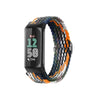 A black watch band with a multicolored, stretchy nylon strap is shown coiled.