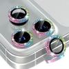 A collection of glitter diamond camera lens protectors with metal frames displayed on a silver surface.
