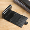 A black premium double layer ID card holder wallet resting on a wooden surface.
