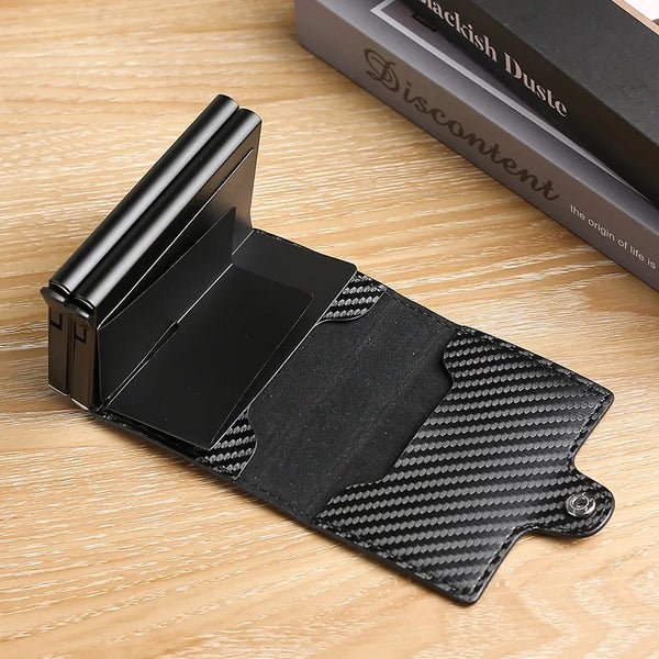A black premium double layer ID card holder wallet resting on a wooden surface.