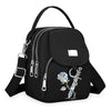 Sac bandoulière floral noir et durable avec fermeture éclair et quincaillerie argentée.