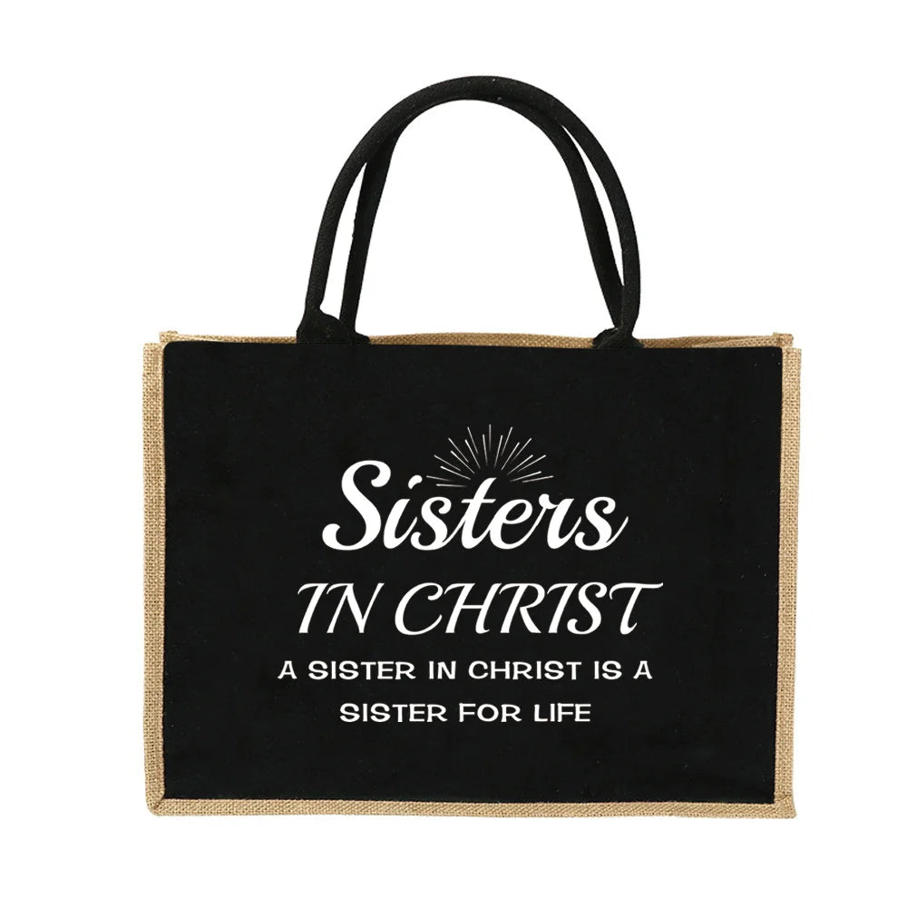 Schwarze Jute-Burlap-Tasche mit weißer Aufschrift: Sisters in Christ, a sister in Christ is a sister for life