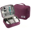 A purple leather cable storage organizer bag open to show various electronic cables and accessories.