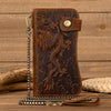 A brown genuine leather bifold wallet featuring an embossed dragon design and a metal chain.