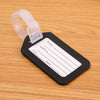 A black luggage tag with a white rectangular area for writing, attached to a clear plastic strap.