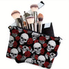 A black makeup pouch featuring a pattern of red roses and skulls, with several makeup brushes inside.