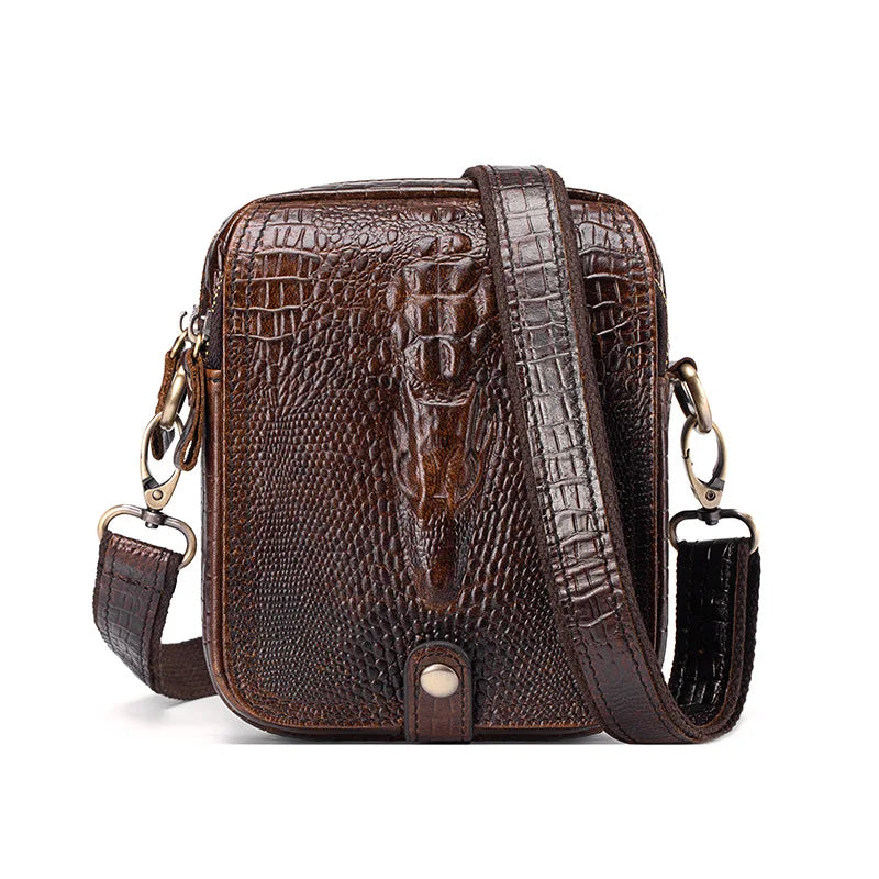 A brown crocodile-textured genuine cow leather crossbody bag for men with a dark strap.