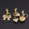 Gold-toned leopard print bow and heart bag charm keychain set