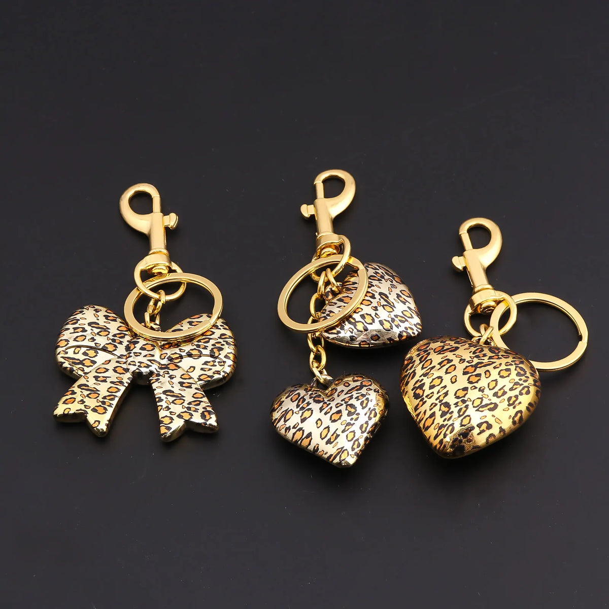 Gold-toned leopard print bow and heart bag charm keychain set