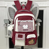 A maroon and white backpack featuring a laptop compartment and decorative lace details.