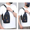A person wearing a white t-shirt is holding a navy blue compact Oxford crossbody sling bag.