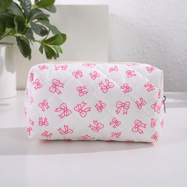 Pochette de maquillage rembourrée blanche avec motif nœud rose