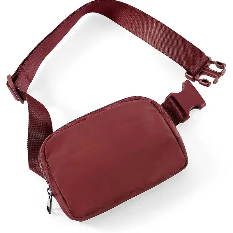 A maroon waist bag or fanny pack with a strap and zipper visible.