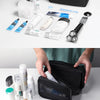 A black travel wash bag is shown open, displaying various toiletries like toothbrushes, toothpaste, and facial cleansers.