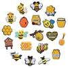 A collection of yellow and black bee-themed decorative shoe charms and pins for clogs and sandals.