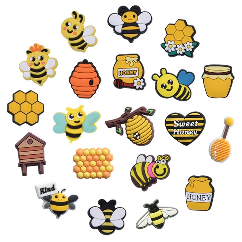 A collection of yellow and black bee-themed decorative shoe charms and pins for clogs and sandals.