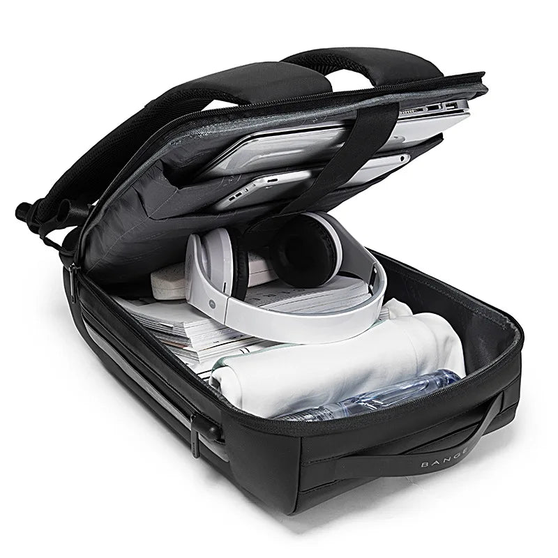 Black anti-theft waterproof laptop backpack open showing a laptop and various accessories.