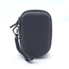 Black durable hard shell case for a digital camera with a strap and attached key ring.