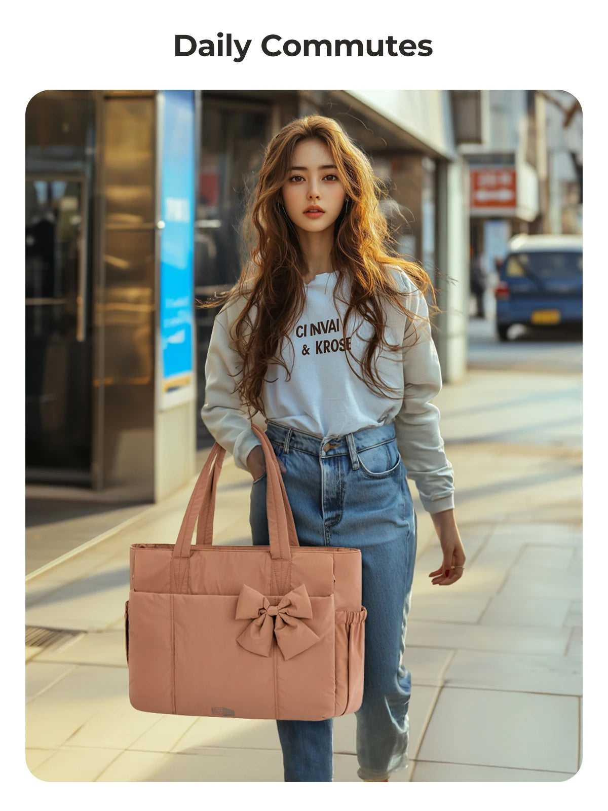 A young woman with long brown hair wearing a light blue sweatshirt and jeans is walking while carrying a large pink tote bag.