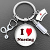 Silver keychain featuring a heart and the word Nursing with a medical syringe charm