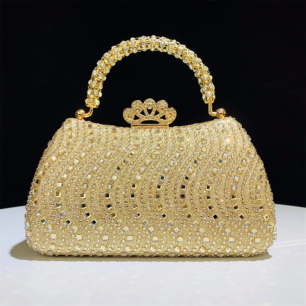 A gold crystal-embellished evening clutch bag with a chain strap resting on a white surface.