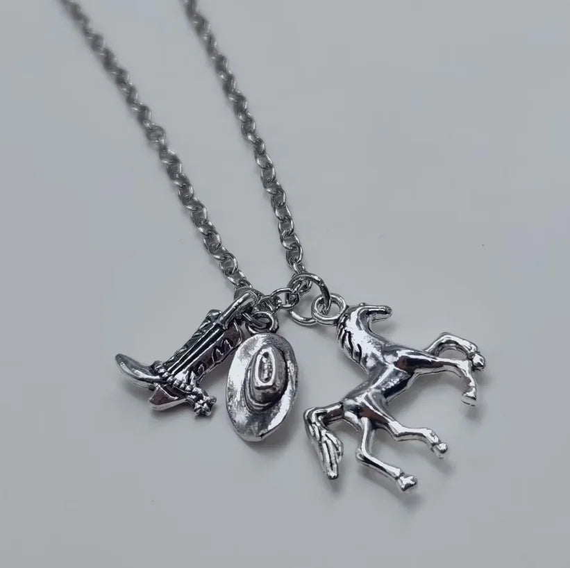 Silver necklace with a cowboy boot, hat, and horse keychain set