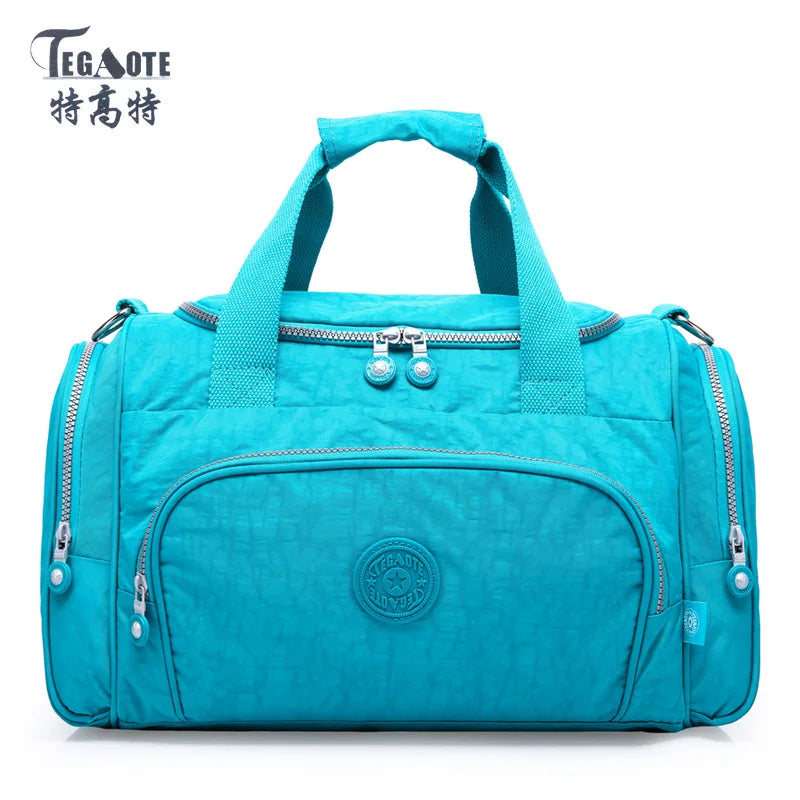 A teal nylon travel duffle bag with zippered compartments and handles.