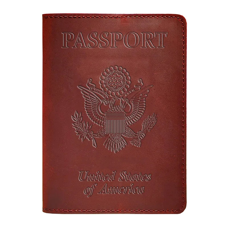 A dark red leather passport holder embossed with the United States of America eagle seal and text.
