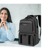 A woman is shown using a black insulated lunch and picnic backpack next to a laptop.