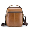Bolso cruz de piel genuina marrón de vaca con asa superior y correa ajustable.