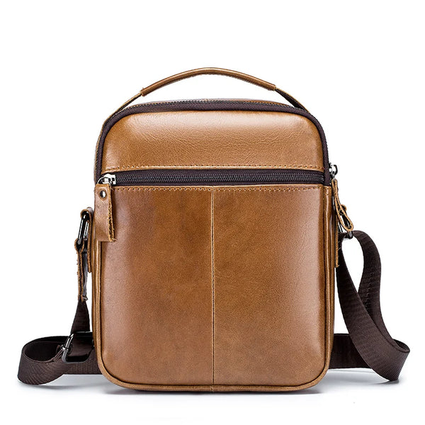A brown genuine leather cowhide crossbody bag with a top handle and adjustable strap.