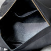Interior view of a black full-grain leather backpack showing the lining and zipper details.