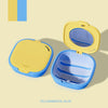 Yellow and royal blue denture storage box with a mirror and drainage feature