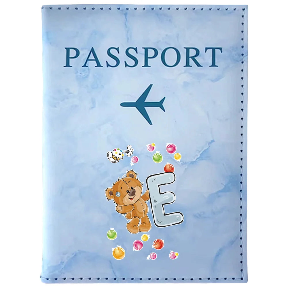 Light blue passport card holder featuring a vintage letter print with the word PASSPORT and the letter E.