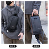 A man is shown wearing a black anti-theft zippered crossbody bag on his shoulder and hand.