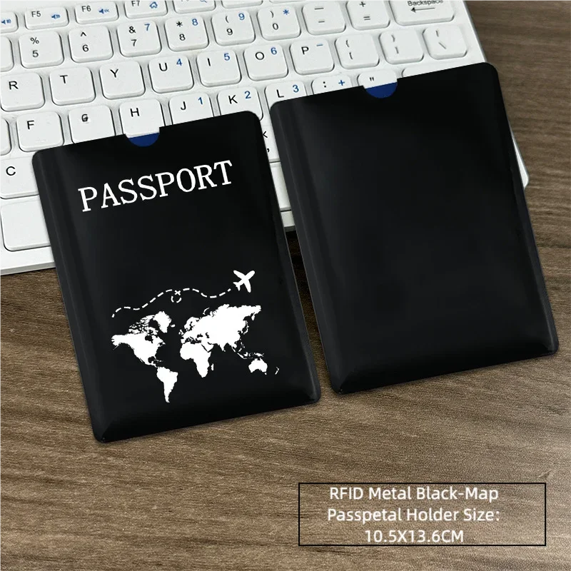Black leather passport holder with a world map design placed on a wooden desk next to a laptop keyboard