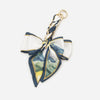 A navy and white adjustable bag strap featuring a decorative bow knot.
