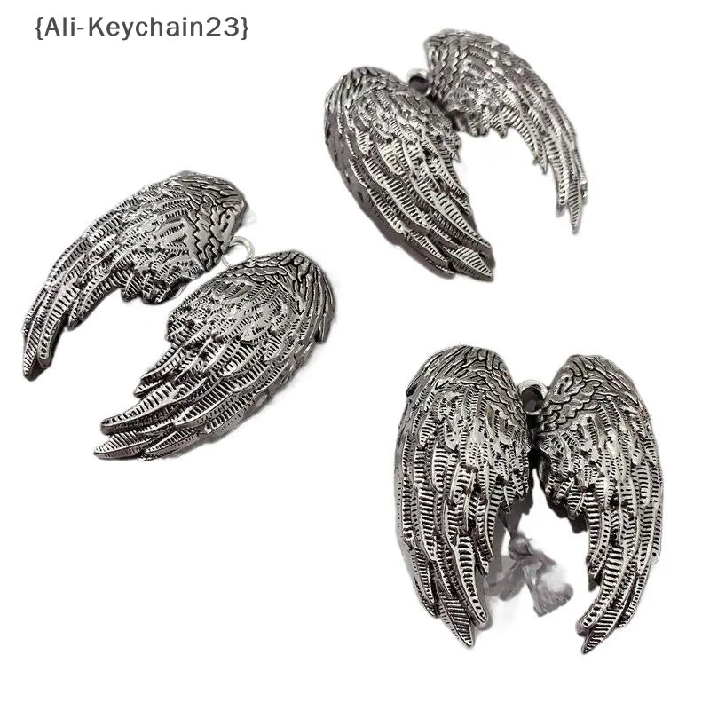 Silver metal angel wing charm keychain featuring detailed feather texture