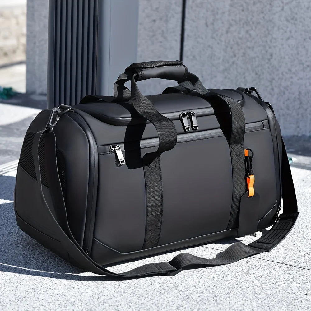 A black large capacity travel duffel bag resting on a light gray outdoor surface.