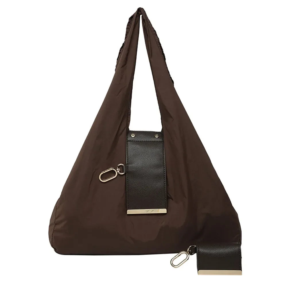 A dark brown foldable mini keychain tote bag with a black leather accent and gold hardware.