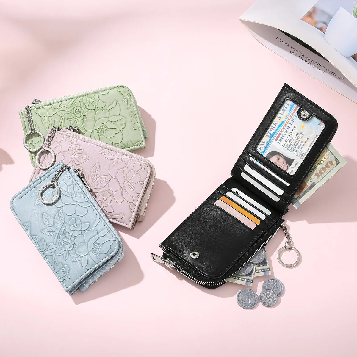 A collection of elegant ladies zip coin purses in mint green and pink, displayed on a light pink background.