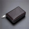 A dark brown leather minimalist multi-card wallet with a silver zipper pull, shown from above.