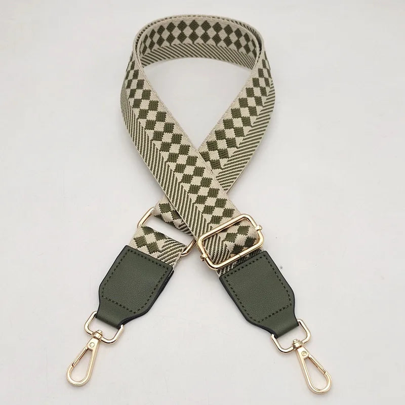 A beige and olive checkered braided nylon bag strap with metal hooks.