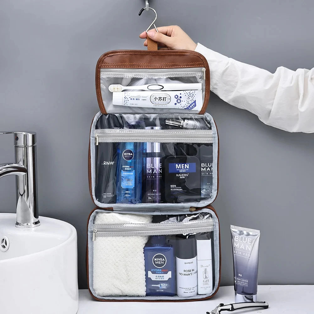 A brown cosmetic organizer bag with clear compartments and a white sponge is being held by a hand.