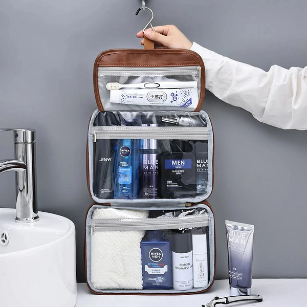 A brown cosmetic organizer bag with clear compartments and a white sponge is being held by a hand.