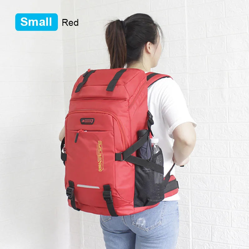 A red small travel backpack with a black rain cover is shown being worn by a woman.