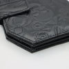 Black leather wallet with vintage embossed design featuring skulls and floral motifs.