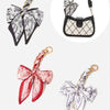 A set of adjustable bag straps featuring floral patterned fabric in black, white, and pink tones.