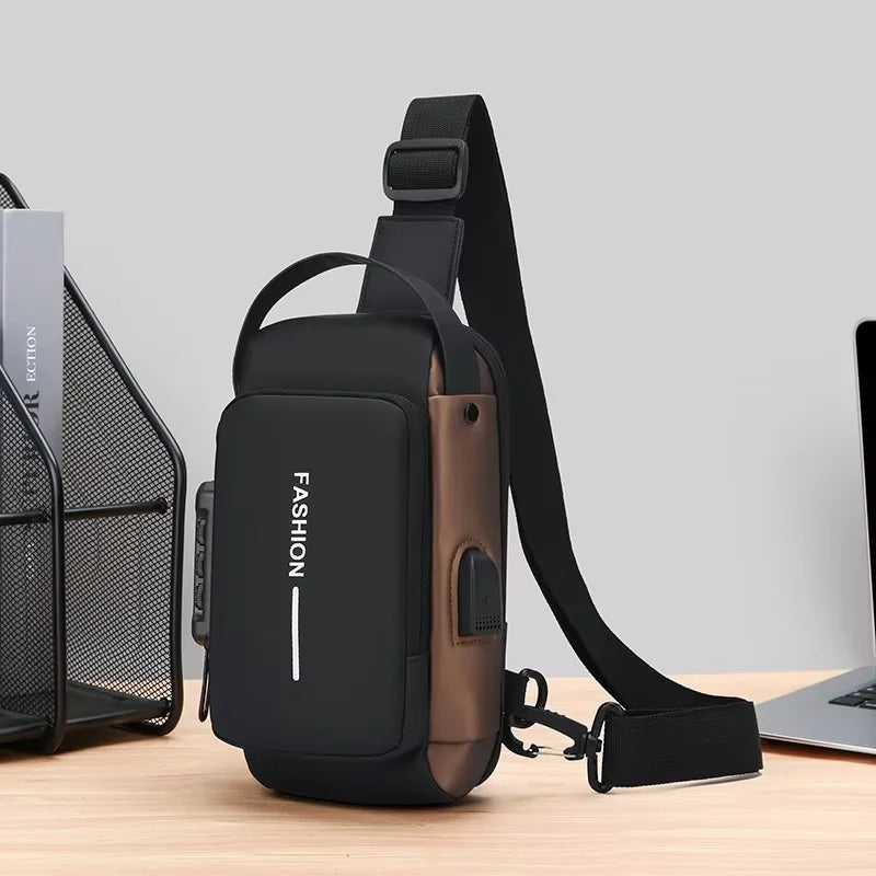 A black men's Oxford sling chest bag with a brown strap and a phone pocket resting on a wooden surface.
